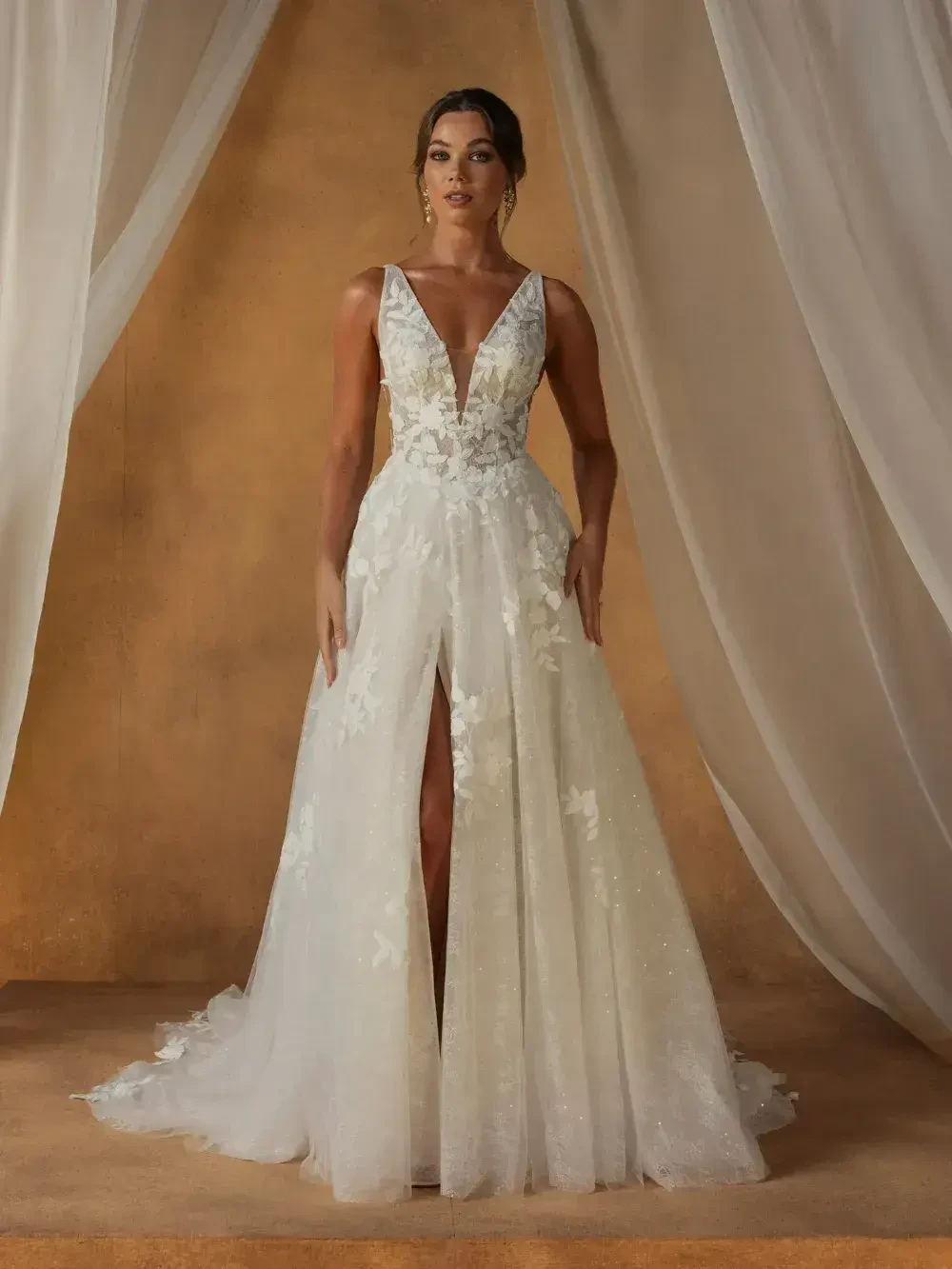 model is wearing a sleeveless bridal gown