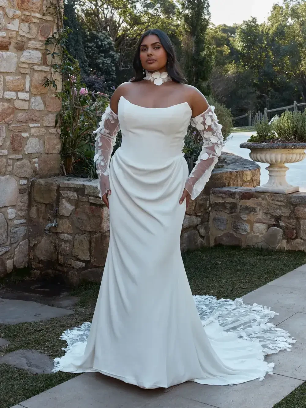 model is wearing a strapless cat eye wedding gown