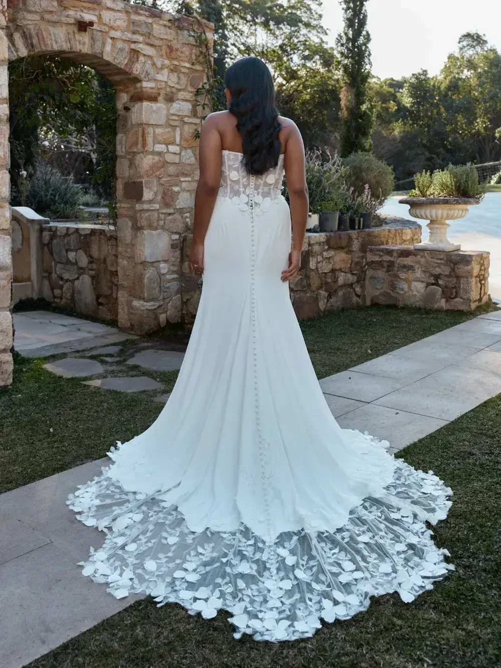 model is wearing a strapless cat eye wedding gown