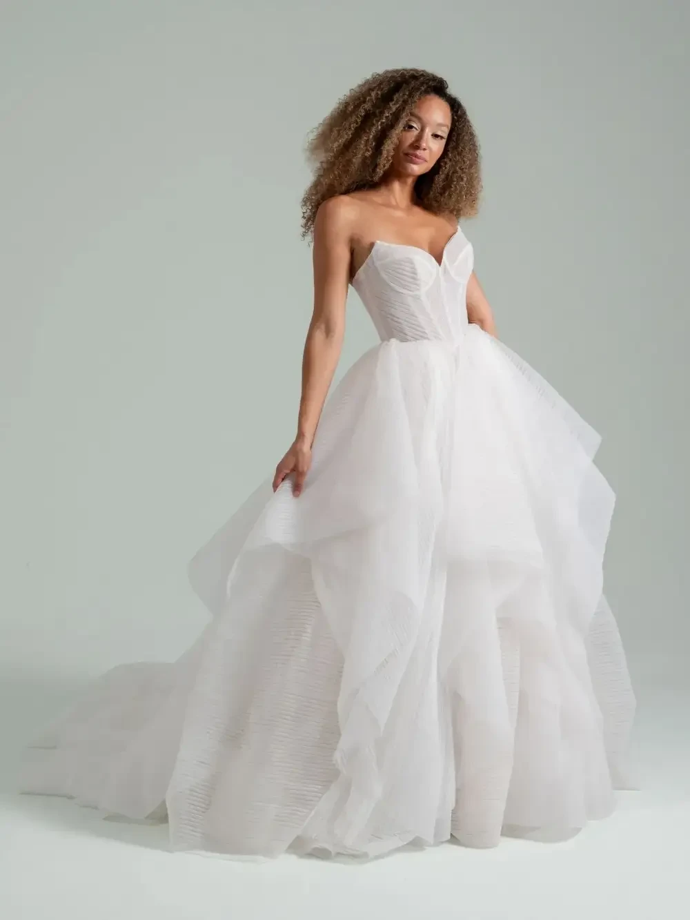 model is wearing a sleeveless bridal gown