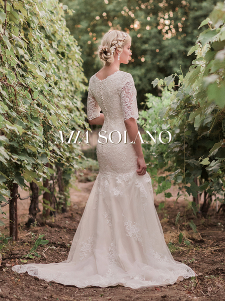 Model wearing a bridal gown by Mia Solano